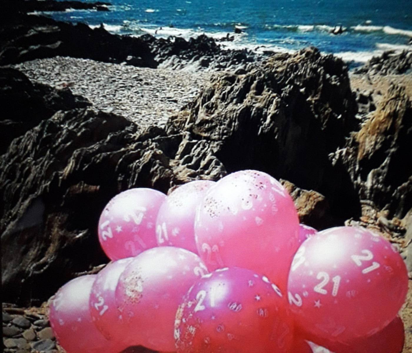 21st birthday celebration  balloons blown on to the beach. 